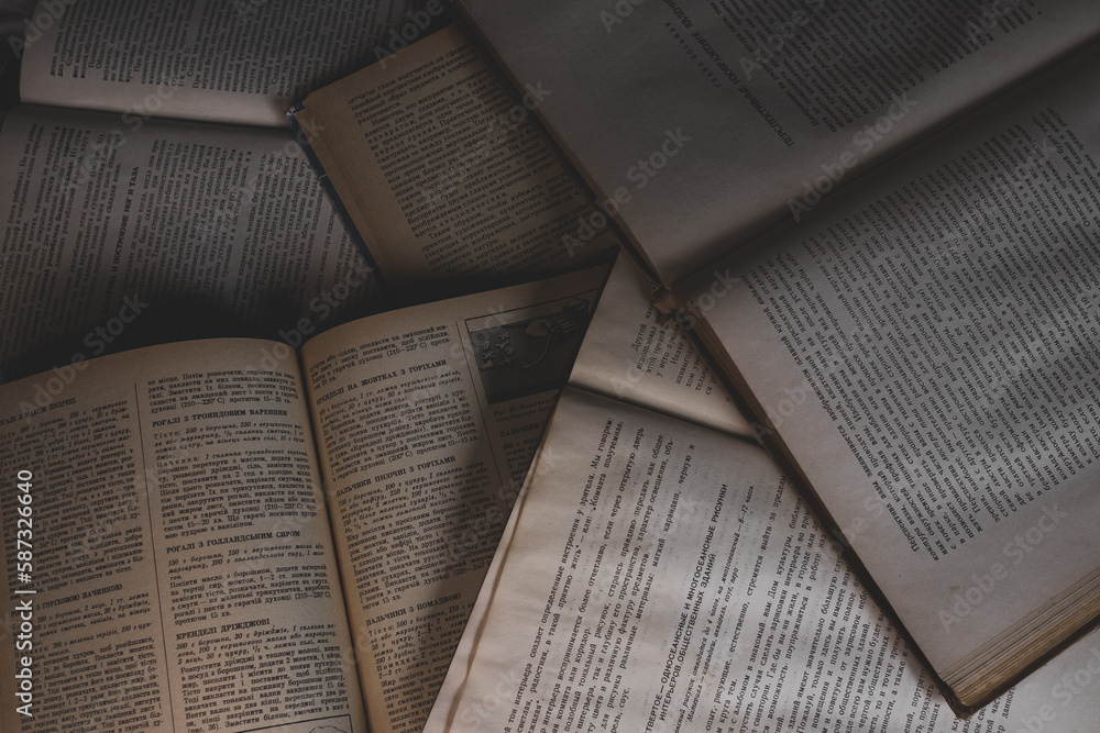 A Stack Of Old Books With Frayed Spines And Yellowed Pages Stock Photo