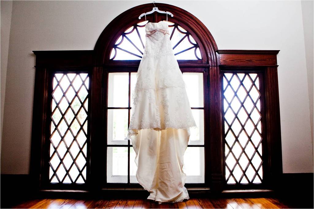 Classic Ivory Lace Wedding Dress Hangs In Gorgeous Florida Window