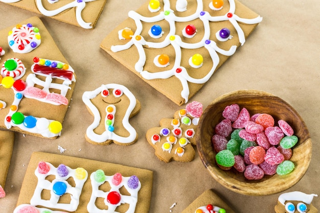 Decorating Gingerbread House With Royal Icing And Colorful Candies