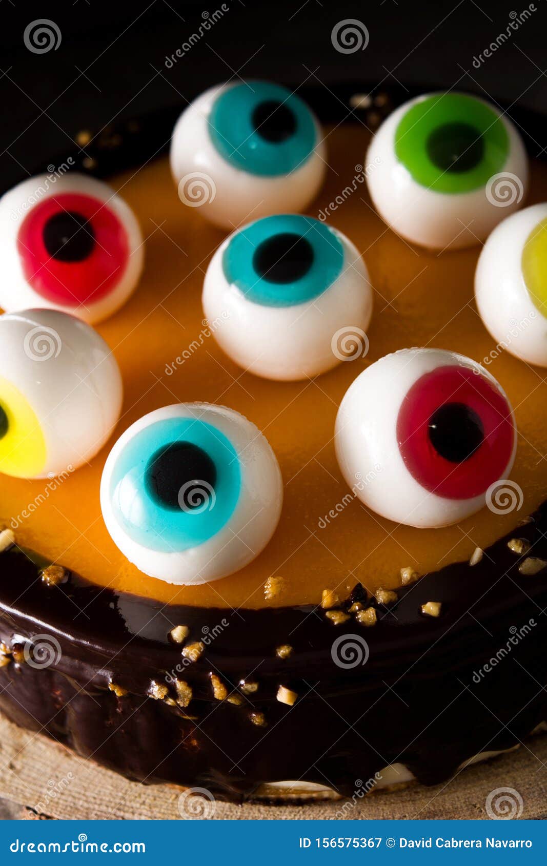 Halloween Cake With Candy Eyes Decoration On Wooden Table Stock Photo