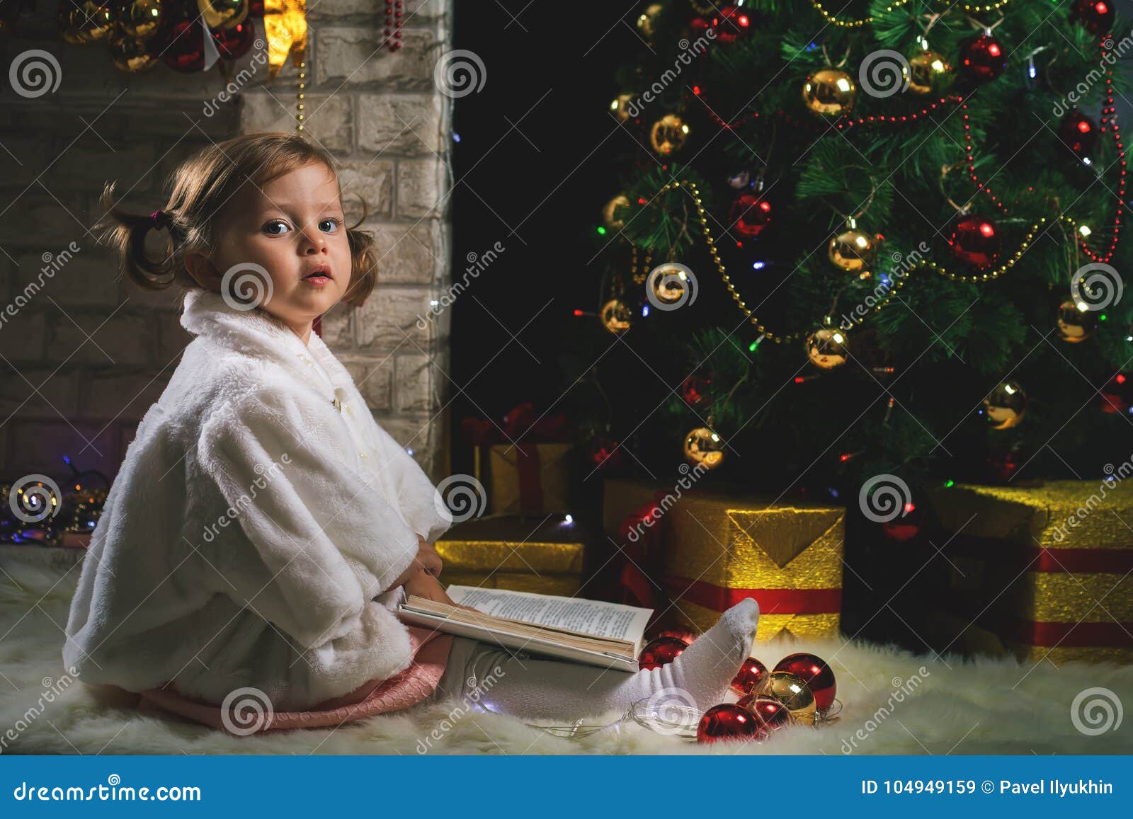 Little Girl Decorating Christmas Tree Before New Year S Eve Stock Photo